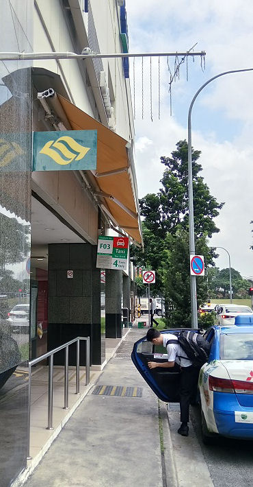 Automatic rain sensing awning passenger waiting for a taxi